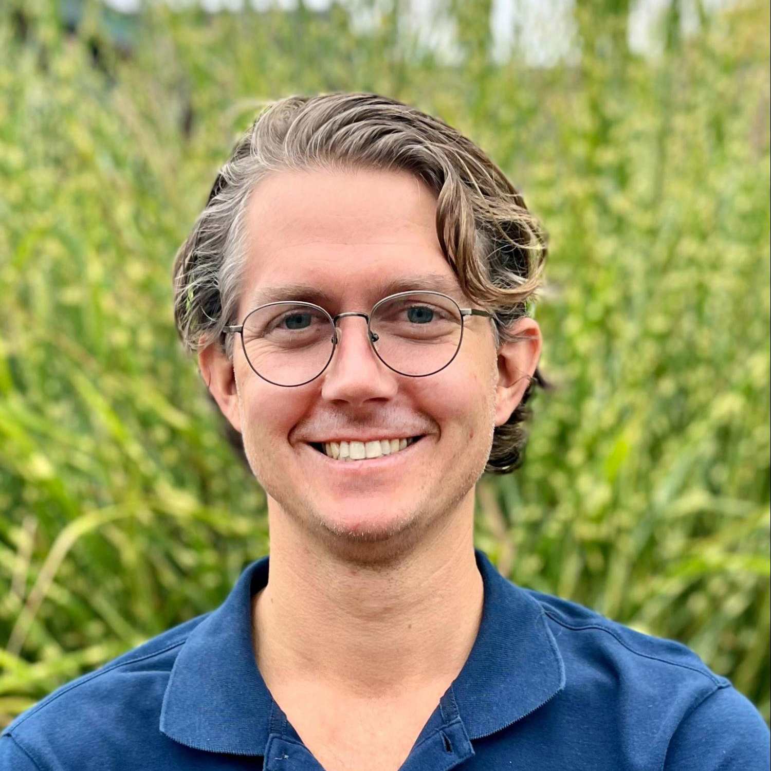 Portrait of Dan in front of green plants